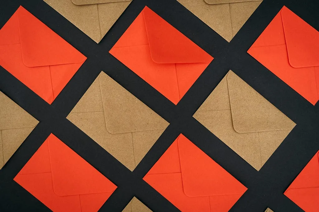 Orange and brown mails organized in a grid and laid diagonally in a checkboard fashion atop a black background.