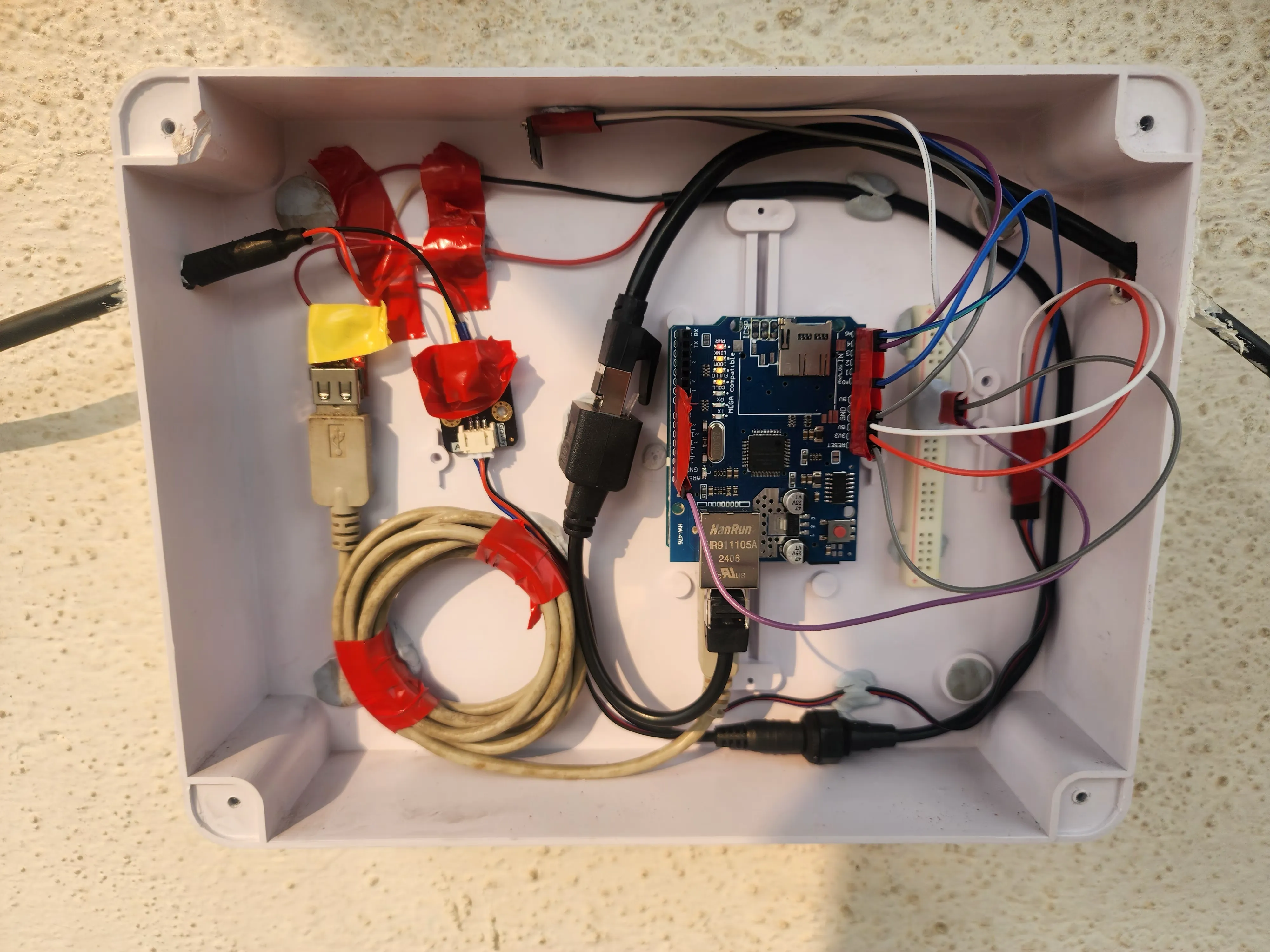Inside the sealed electrical box with the Arduino, ethernet shield, PoE splitter, and buck converter.